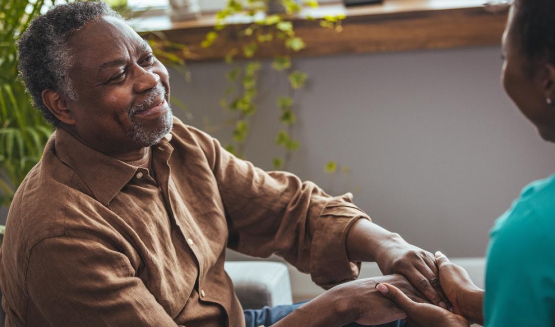 Old black man with dementia holding hands with someone
