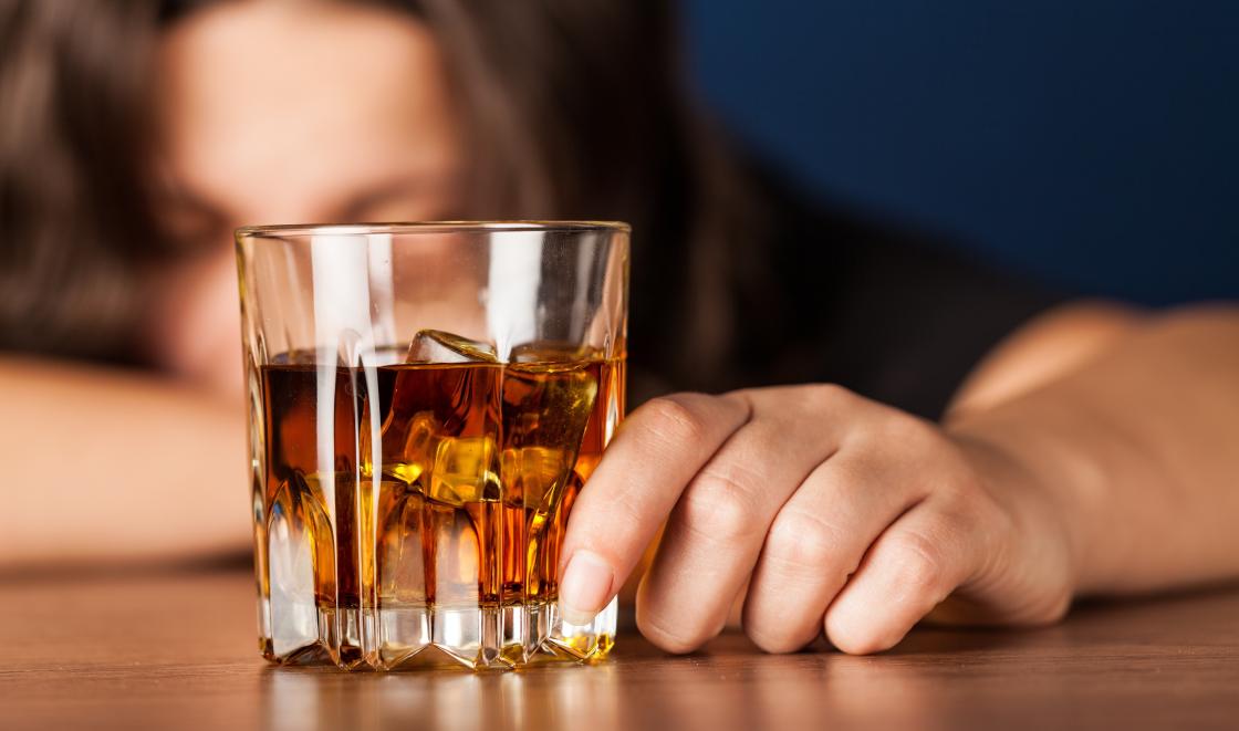 Woman with glass of whiskey