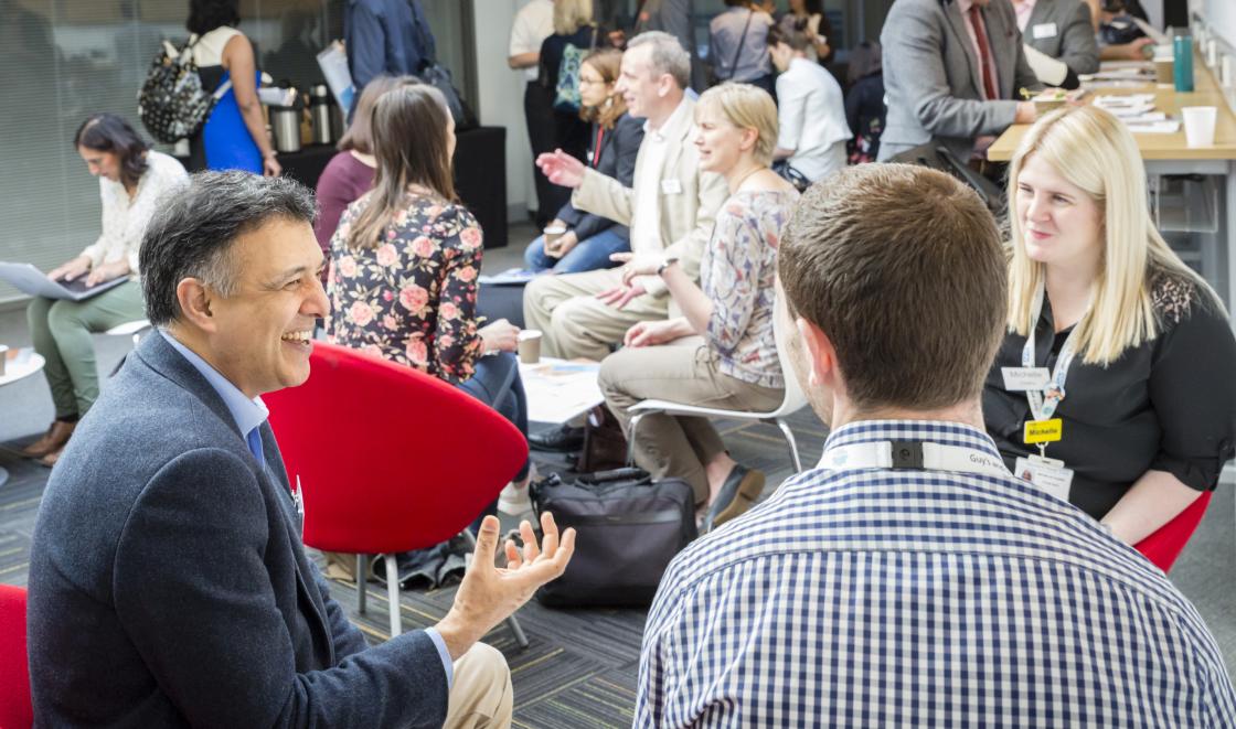 Researchers sitting discussing and networking
